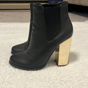 Black boots with a gold heel